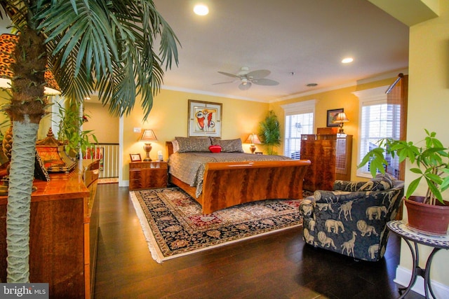 bedroom featuring dark hardwood / wood-style floors, ceiling fan, and crown molding