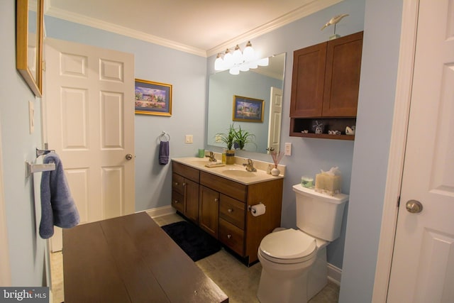 bathroom with vanity, toilet, and ornamental molding