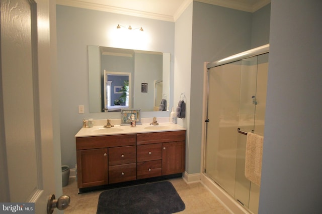 bathroom featuring tile patterned flooring, vanity, a shower with door, and crown molding