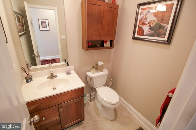 bathroom featuring tile patterned floors, vanity, and toilet