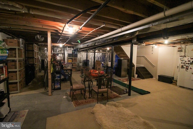 basement featuring white fridge