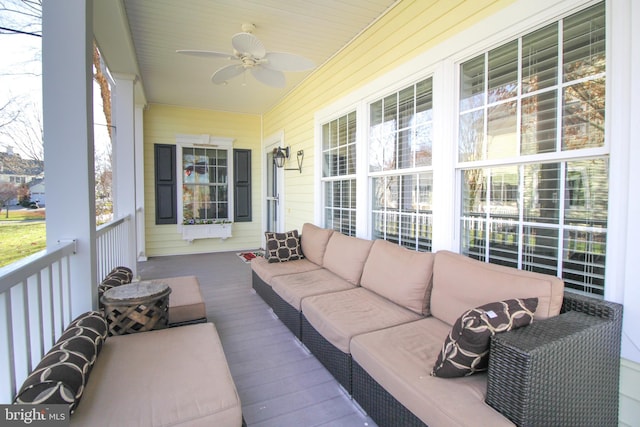 sunroom / solarium featuring ceiling fan