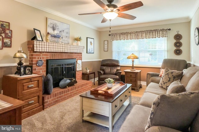 living room featuring ornamental molding, a brick fireplace, and ceiling fan