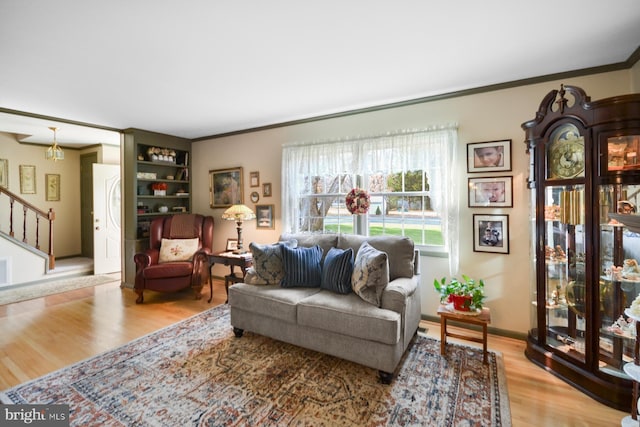 living room featuring crown molding and light hardwood / wood-style floors