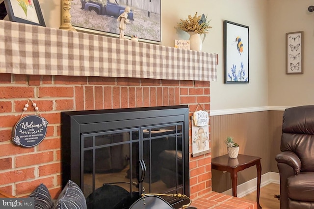 interior details with a brick fireplace and hardwood / wood-style flooring