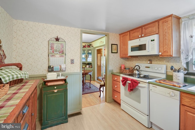 kitchen featuring white appliances and light hardwood / wood-style floors