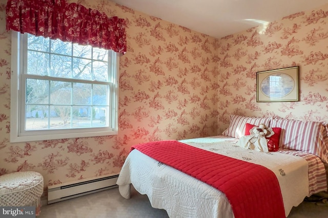 bedroom with carpet floors and a baseboard radiator