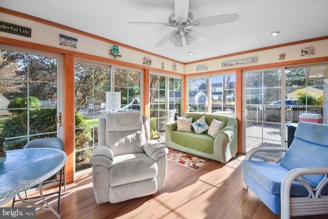 sunroom featuring ceiling fan