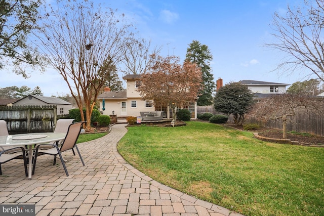 view of yard with a hot tub and a patio