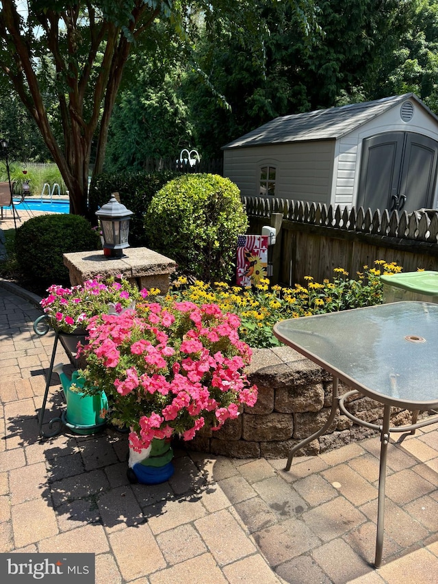 view of patio with a storage unit