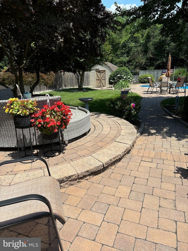 view of patio / terrace with a shed