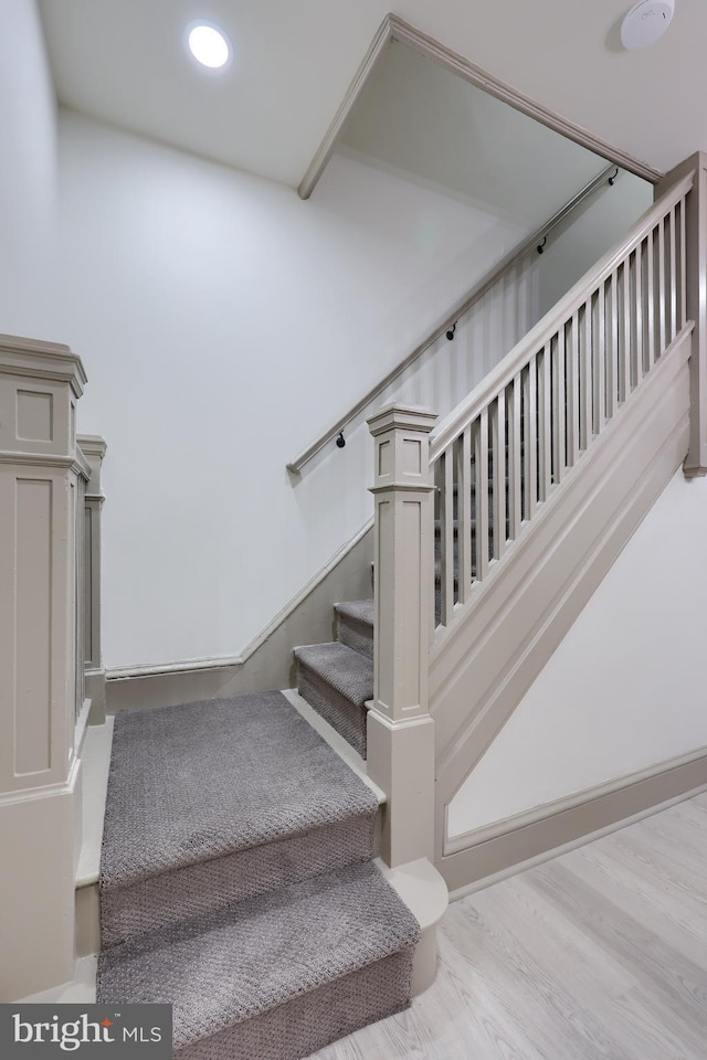 stairs with wood-type flooring