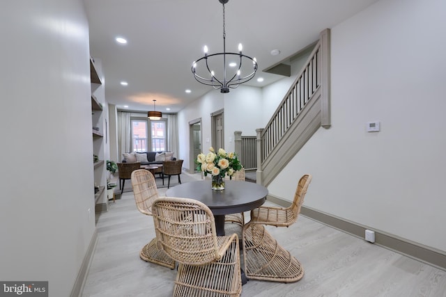 dining area with a notable chandelier and light wood-type flooring