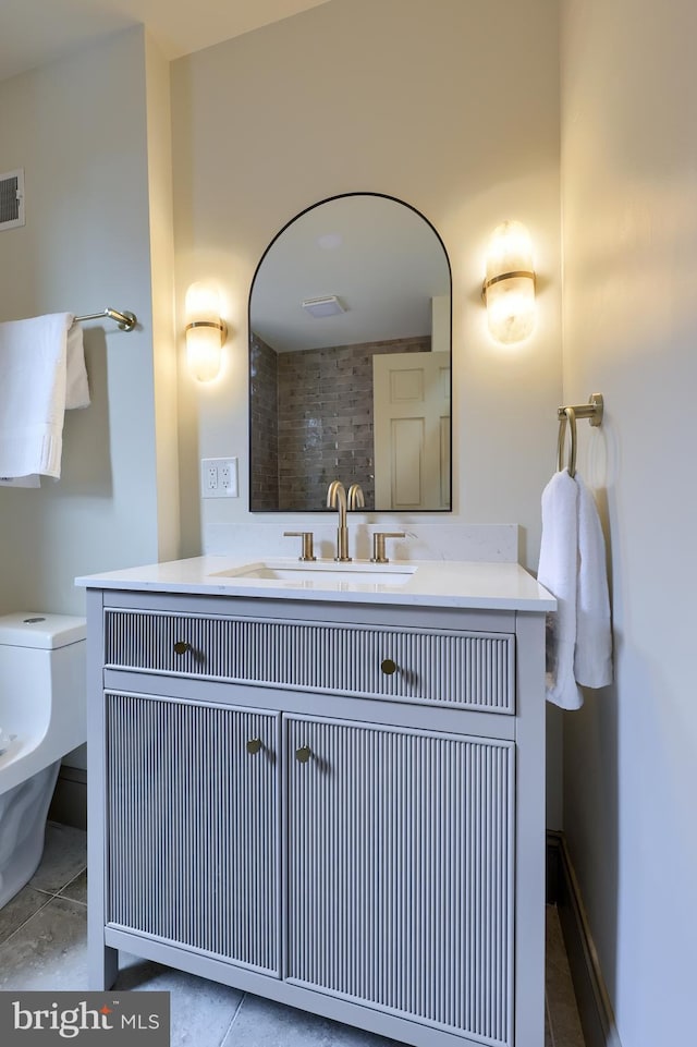 bathroom with tile patterned floors, vanity, and toilet