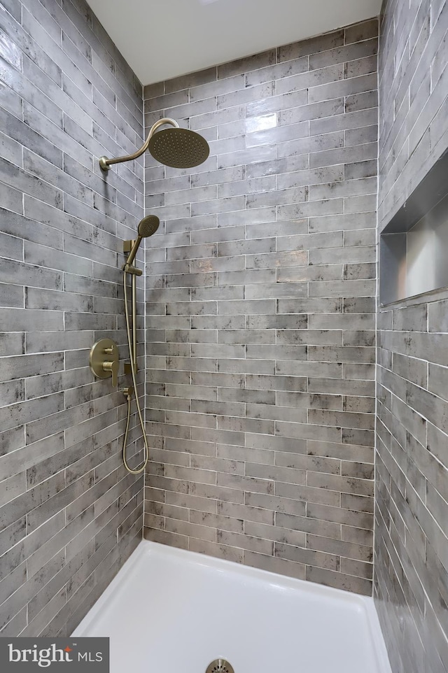 bathroom with tiled shower