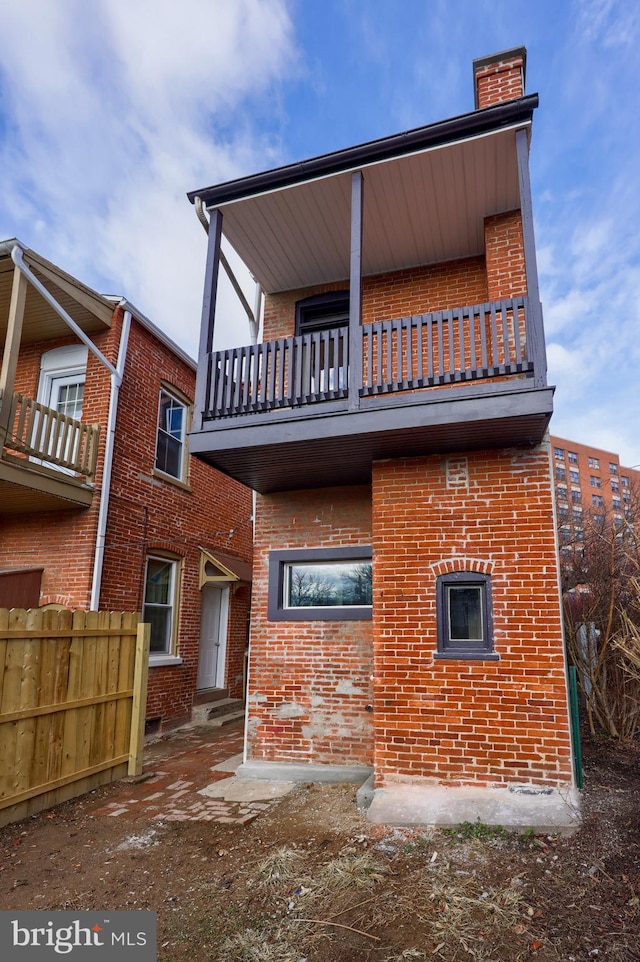 back of house featuring a balcony