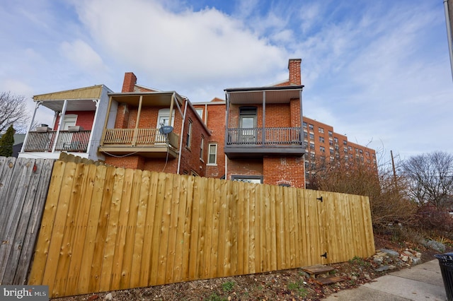 back of property with a balcony