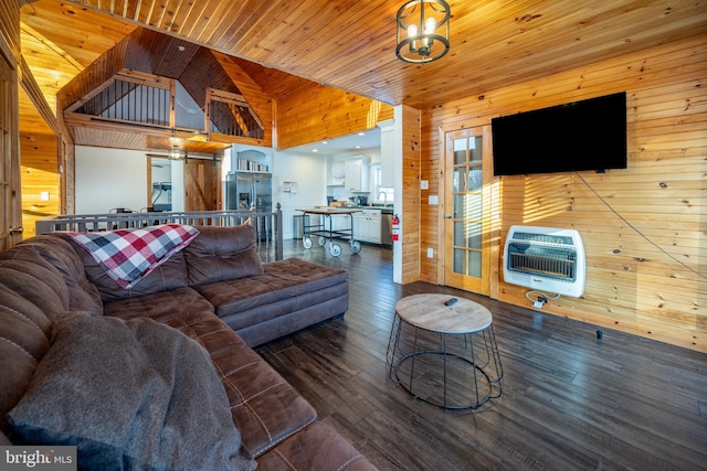 living room with heating unit, wooden walls, high vaulted ceiling, and wood ceiling