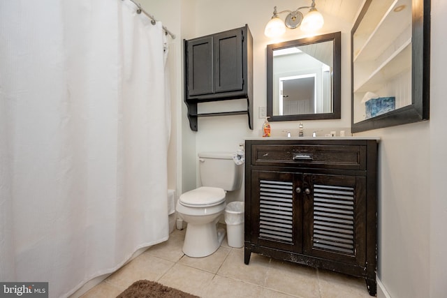 bathroom featuring tile patterned floors, vanity, and toilet