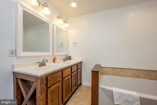 bathroom with tile patterned floors, vanity, and a bath