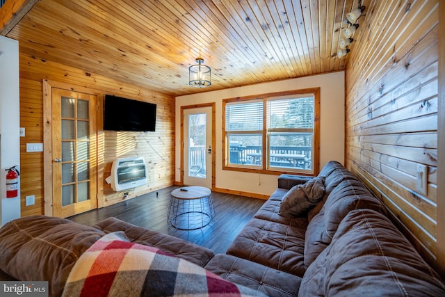 living room with wood-type flooring, heating unit, wood ceiling, and wood walls