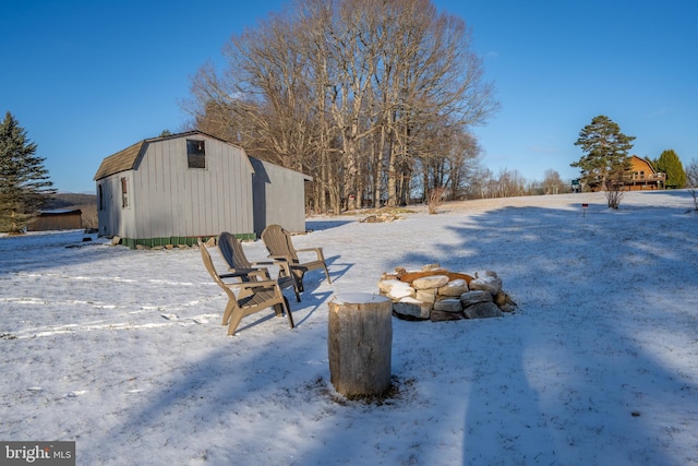 snowy yard with an outbuilding