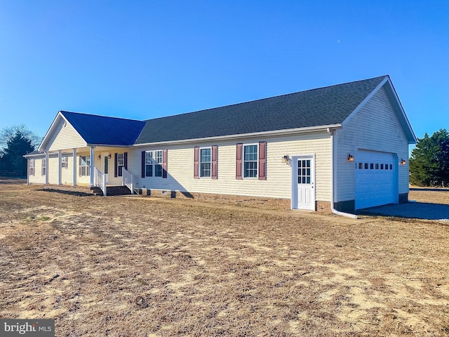 single story home with covered porch and a garage