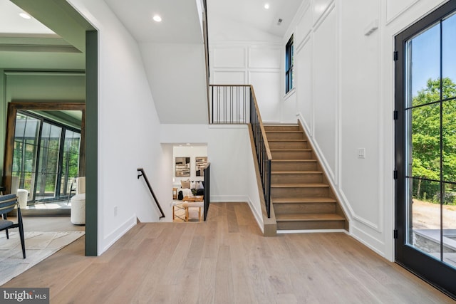 staircase featuring hardwood / wood-style flooring and vaulted ceiling