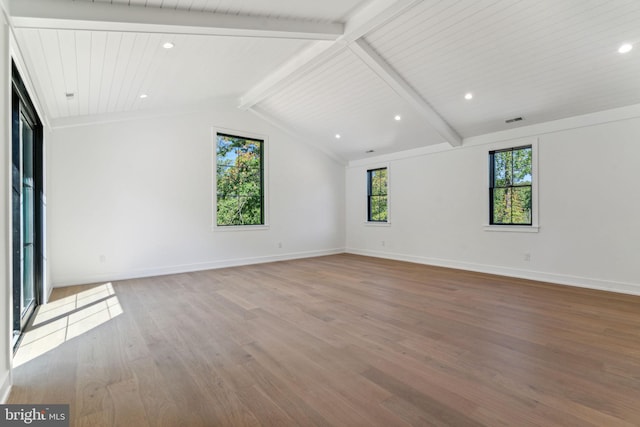 interior space featuring hardwood / wood-style floors and lofted ceiling with beams