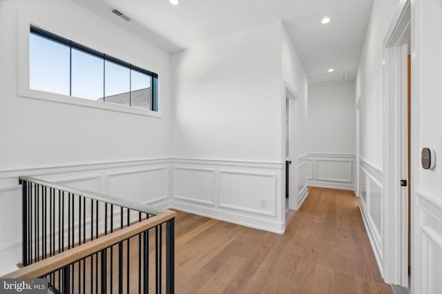 hallway with light hardwood / wood-style flooring