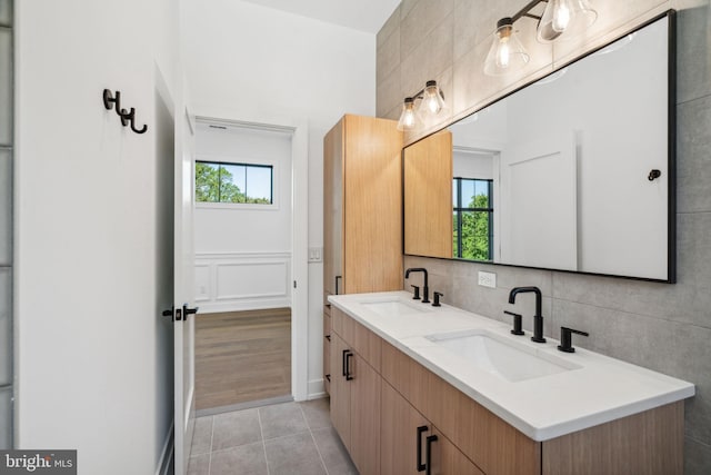 bathroom featuring tile patterned flooring, vanity, and plenty of natural light