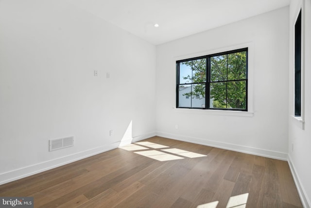 spare room with hardwood / wood-style flooring