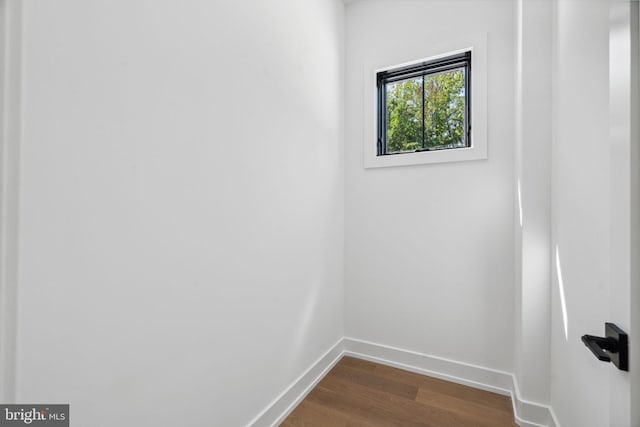 unfurnished room with wood-type flooring