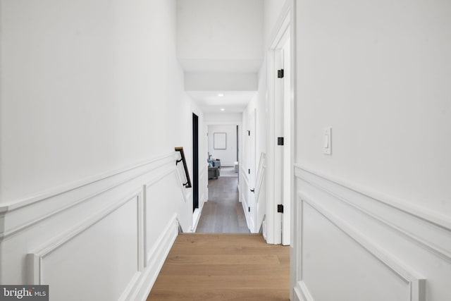 corridor with light hardwood / wood-style floors