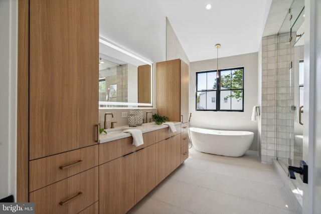 bathroom with tile patterned floors, vanity, and independent shower and bath