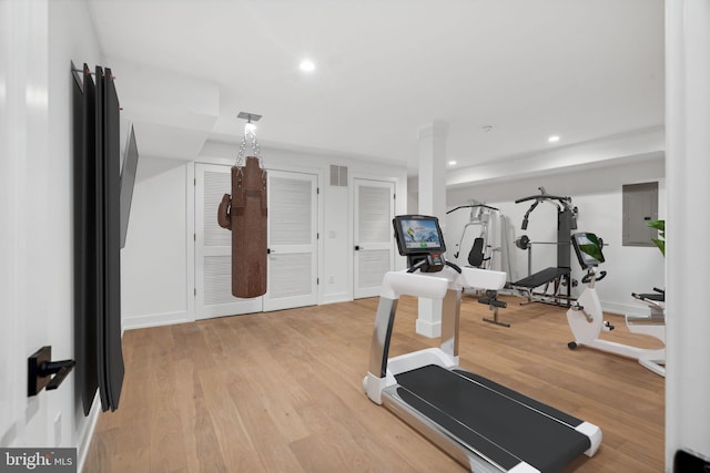 exercise area featuring hardwood / wood-style flooring