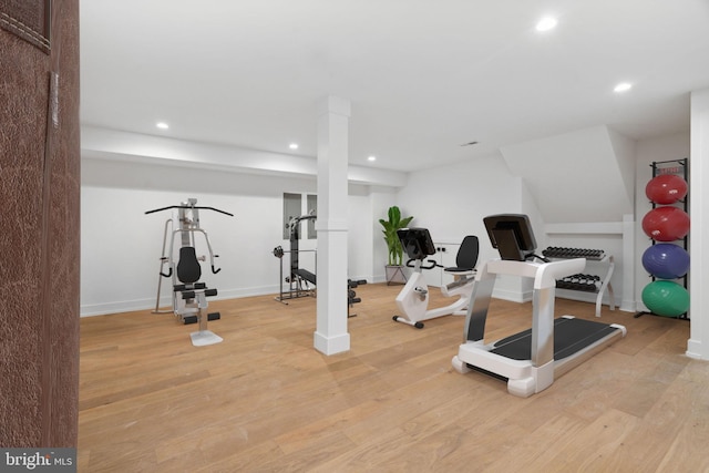 workout room with light hardwood / wood-style flooring