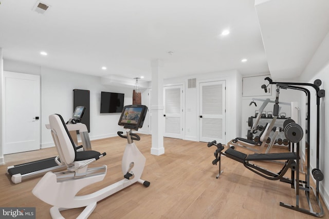 exercise area with light hardwood / wood-style floors