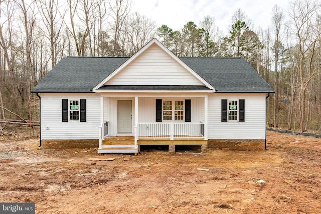 view of front of property with a shingled roof and a porch