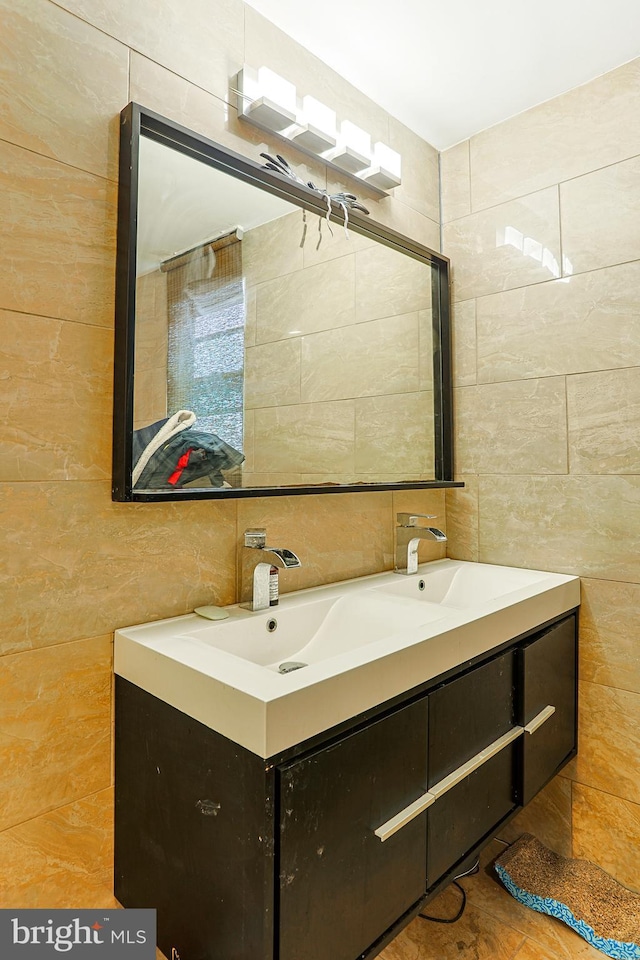 bathroom featuring tile walls and vanity