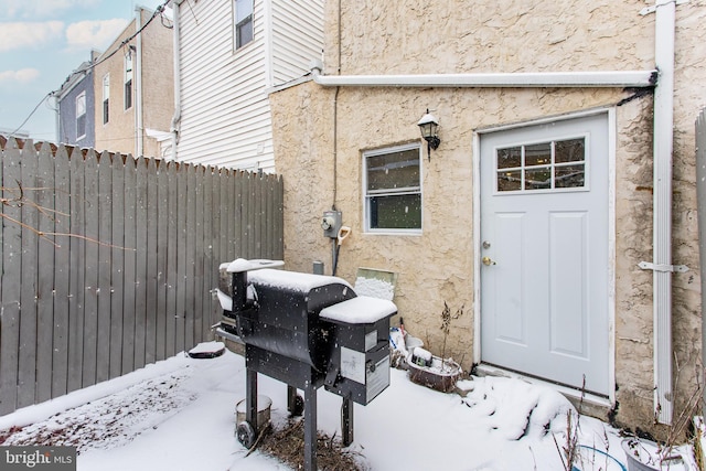 view of snow covered property entrance