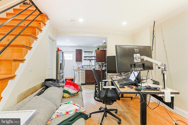 home office with ornamental molding and light hardwood / wood-style flooring