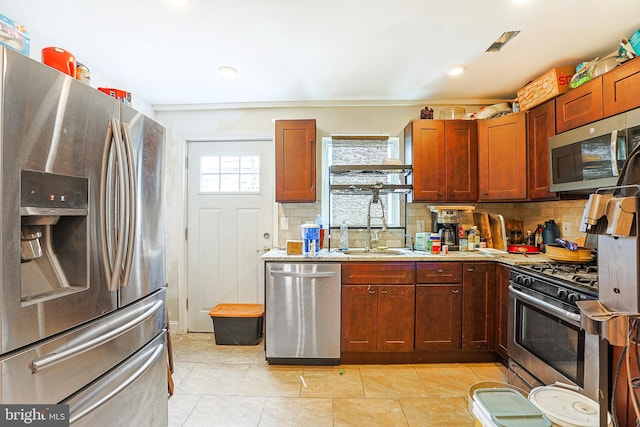 kitchen with stainless steel appliances, decorative backsplash, and plenty of natural light