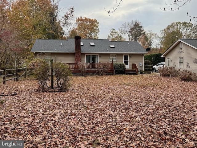 rear view of property with a wooden deck