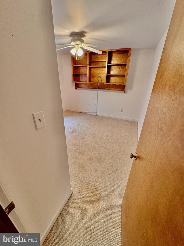 empty room featuring carpet and ceiling fan