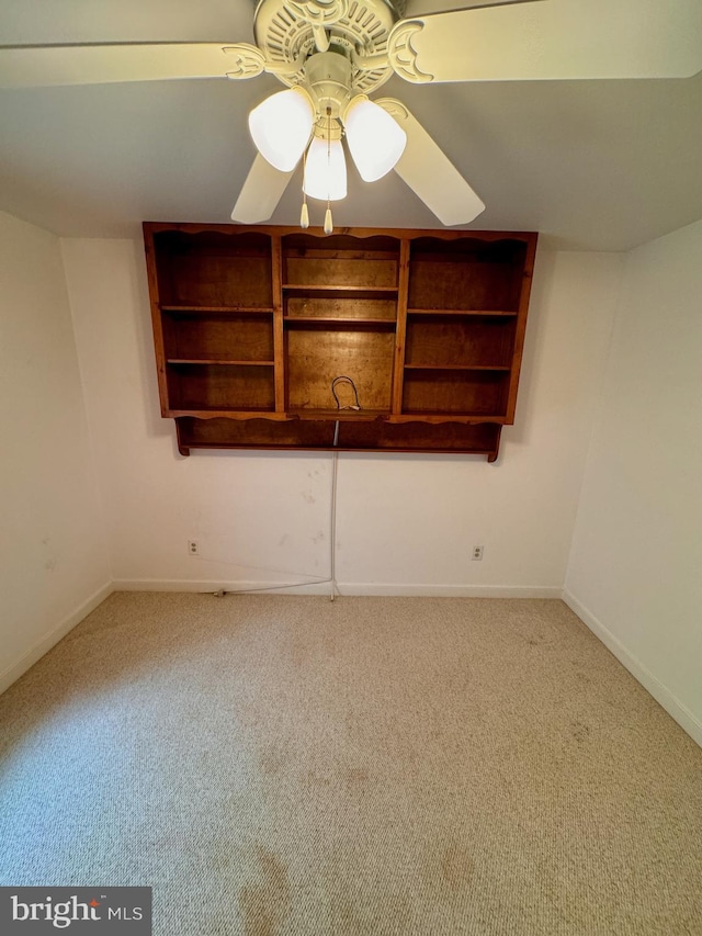 carpeted empty room featuring ceiling fan