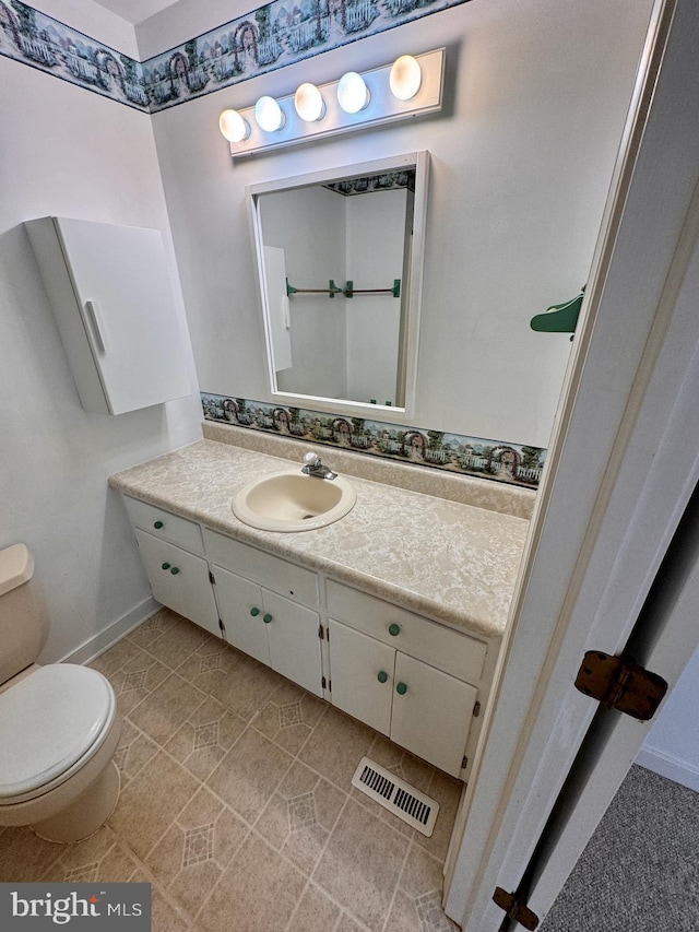 bathroom featuring vanity and toilet