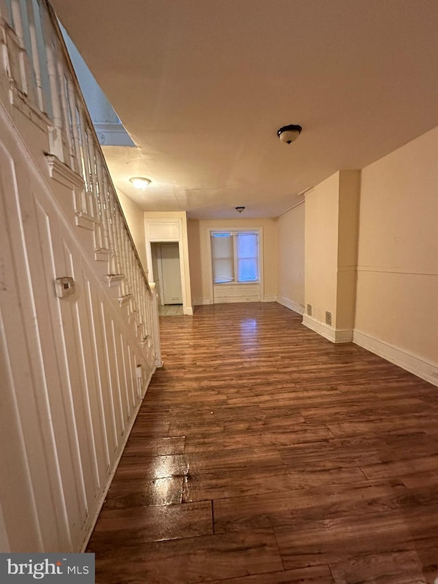 unfurnished living room featuring dark wood-type flooring