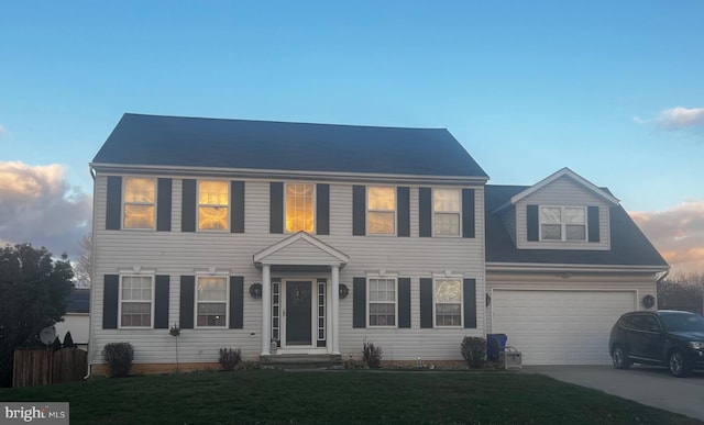 colonial home featuring a lawn