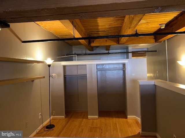 interior space with light hardwood / wood-style flooring and wood ceiling